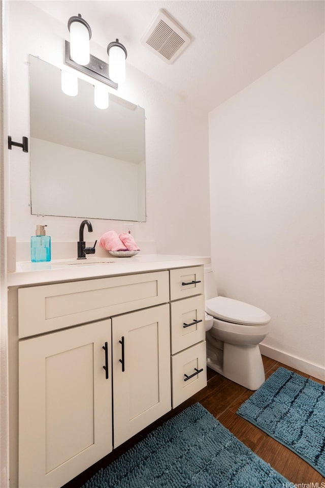 94-1081 Anania Cir Unit 12, Mililani, HI 96789 - bathroom featuring visible vents, wood finished floors, toilet, and vanity