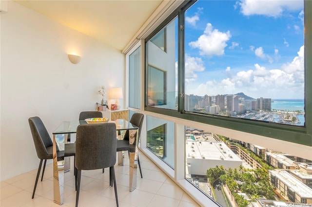 sunroom / solarium featuring a city view, healthy amount of natural light, and vaulted ceiling