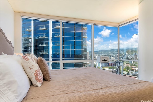 bedroom with floor to ceiling windows and a city view