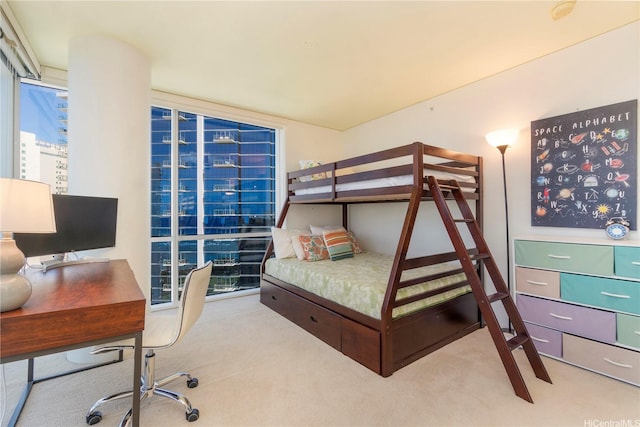 carpeted bedroom with an office area