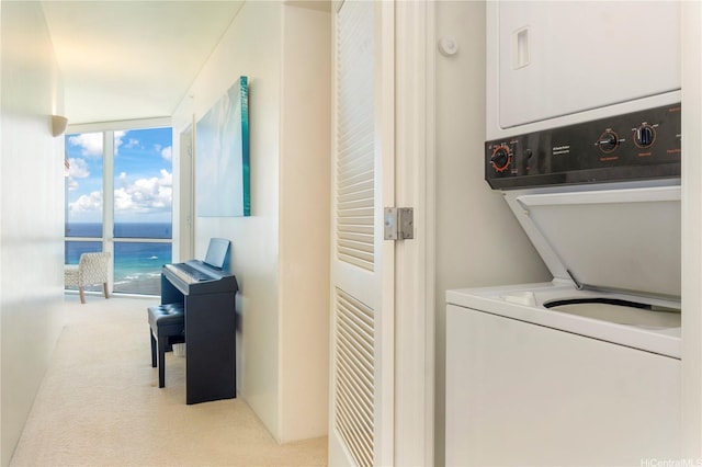 washroom featuring estacked washer and dryer and carpet