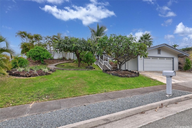 view of front of property featuring a garage, a front yard, and concrete driveway