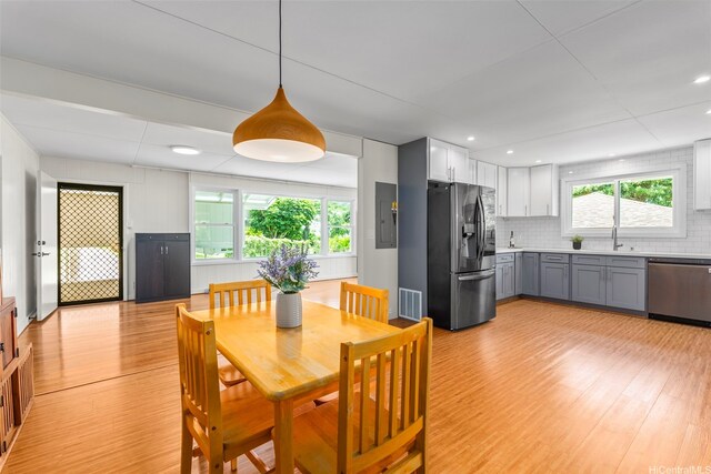 dining area with light wood finished floors and recessed lighting