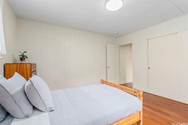bedroom featuring wood finished floors and a closet