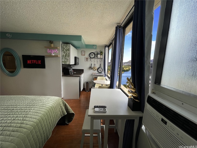 bedroom featuring dark wood-style flooring and a textured ceiling