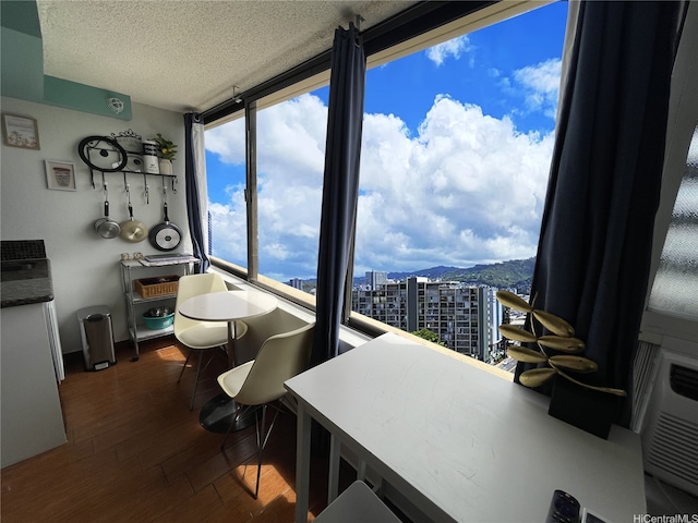444 Niu St Unit 2513, Honolulu, HI 96815 - dining room featuring a textured ceiling, a city view, and dark wood-style floors
