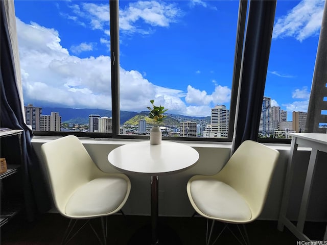 dining room featuring a mountain view and a city view