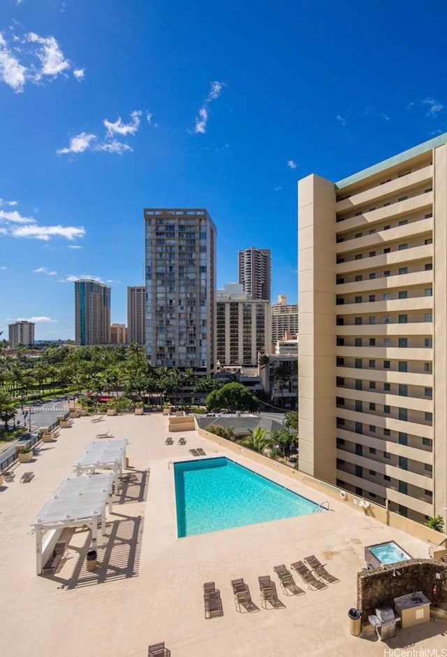 pool featuring a view of city and a patio area