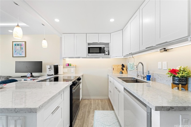 2611 Ala Wai Blvd Unit 1805, Honolulu, HI 96815 - kitchen with a sink, dishwasher, stainless steel microwave, black electric range, and light wood-style flooring