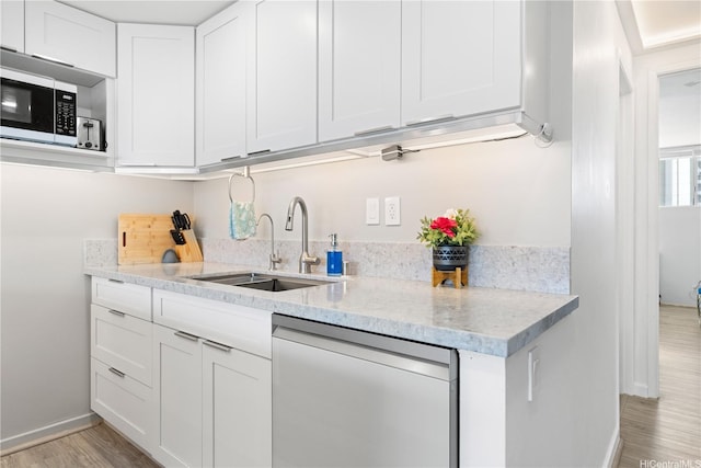 2611 Ala Wai Blvd Unit 1805, Honolulu, HI 96815 - kitchen with dishwasher, a sink, stainless steel microwave, light wood-style floors, and baseboards