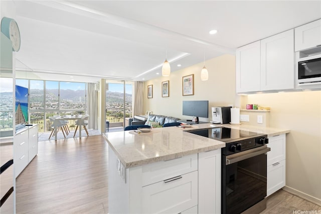 2611 Ala Wai Blvd Unit 1805, Honolulu, HI 96815 - kitchen featuring range with electric cooktop, a peninsula, light wood-type flooring, white cabinets, and light stone counters