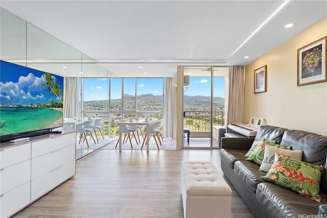 2611 Ala Wai Blvd Unit 1805, Honolulu, HI 96815 - living area featuring a wall of windows, a mountain view, healthy amount of natural light, and wood finished floors