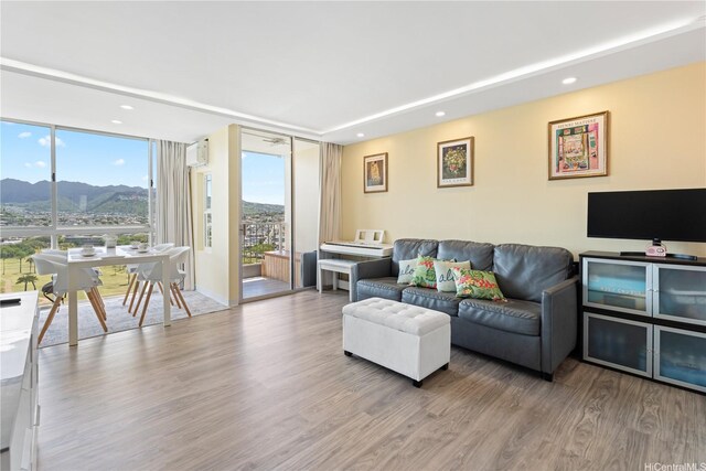 2611 Ala Wai Blvd Unit 1805, Honolulu, HI 96815 - living room featuring a mountain view, wood finished floors, expansive windows, and recessed lighting