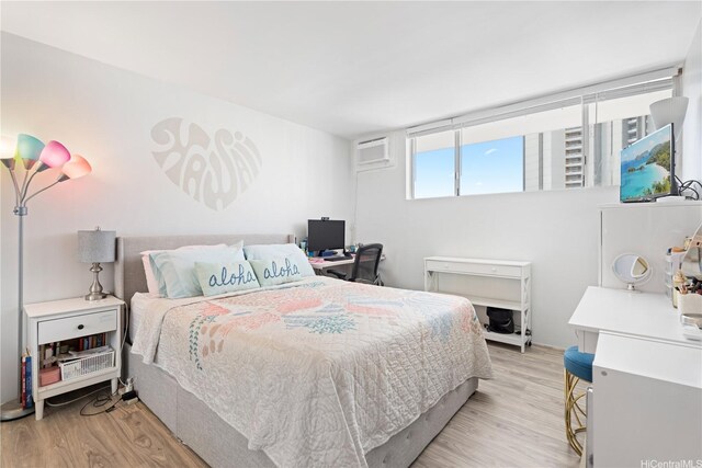 2611 Ala Wai Blvd Unit 1805, Honolulu, HI 96815 - bedroom with light wood-type flooring and an AC wall unit