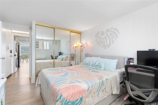 2611 Ala Wai Blvd Unit 1805, Honolulu, HI 96815 - bedroom featuring wood finished floors, an AC wall unit, and a closet