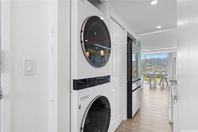 2611 Ala Wai Blvd Unit 1805, Honolulu, HI 96815 - laundry room featuring stacked washer and clothes dryer, light wood-type flooring, and recessed lighting