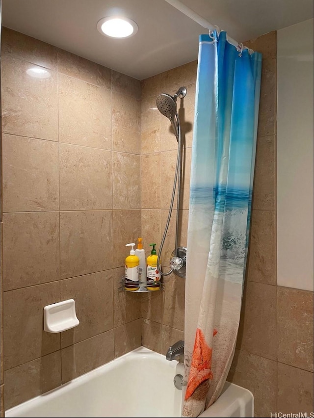 bathroom featuring shower / tub combo with curtain