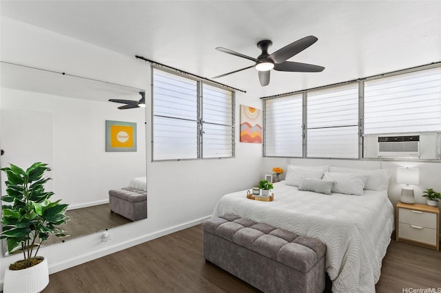 bedroom with baseboards, wood finished floors, and cooling unit