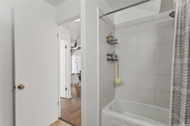 bathroom with shower / bath combo with shower curtain and a ceiling fan