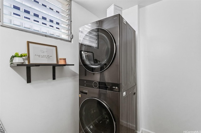 clothes washing area with stacked washer / drying machine and laundry area
