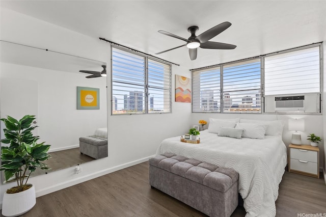 bedroom featuring baseboards, ceiling fan, wood finished floors, and cooling unit