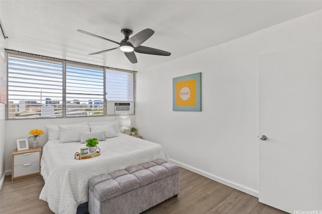 bedroom with baseboards, a ceiling fan, and wood finished floors