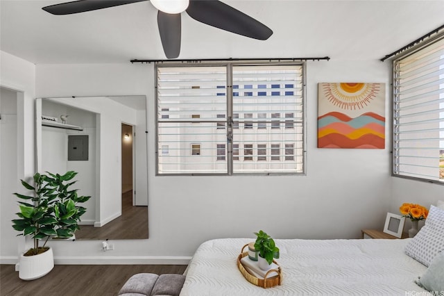 bedroom with baseboards, ceiling fan, and wood finished floors