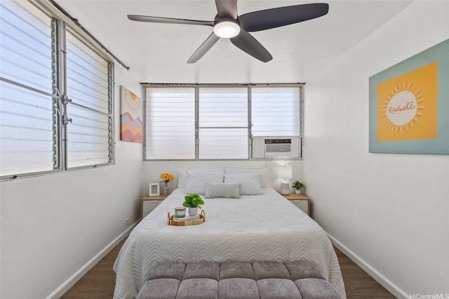 bedroom featuring baseboards, ceiling fan, wood finished floors, and cooling unit