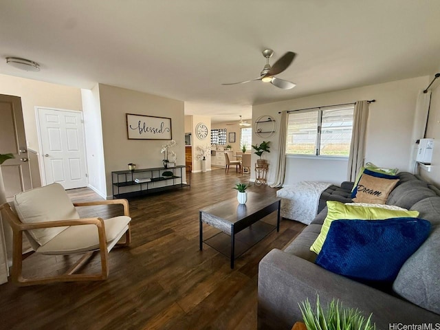 living room with a ceiling fan and dark wood-style flooring