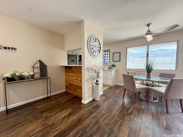 dining space with baseboards, a ceiling fan, and dark wood-style flooring