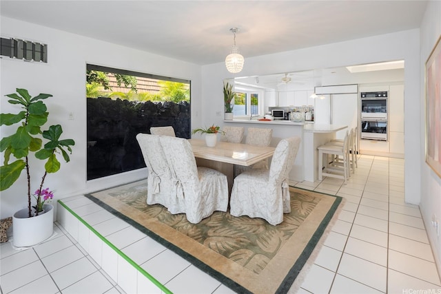 dining area featuring light tile patterned flooring and ceiling fan