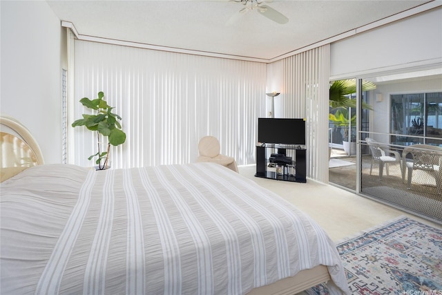 bedroom featuring a ceiling fan, access to exterior, and carpet floors