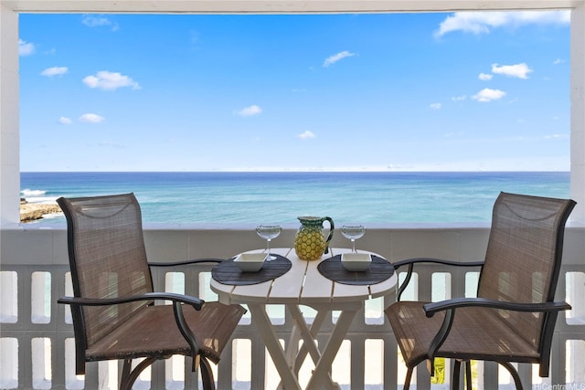 balcony with a water view and a beach view