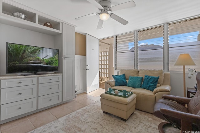 living room featuring a healthy amount of sunlight, a ceiling fan, and light tile patterned floors
