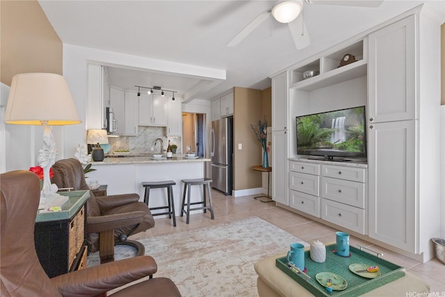 living room featuring a ceiling fan and light tile patterned floors