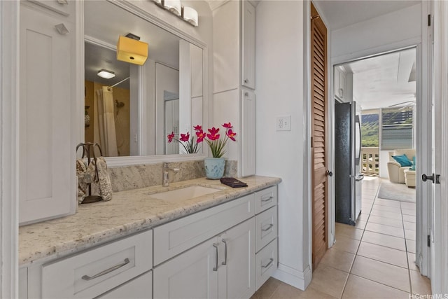 bathroom featuring tile patterned flooring and vanity