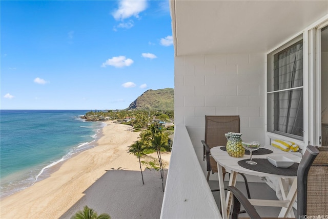 balcony with a water view and a beach view
