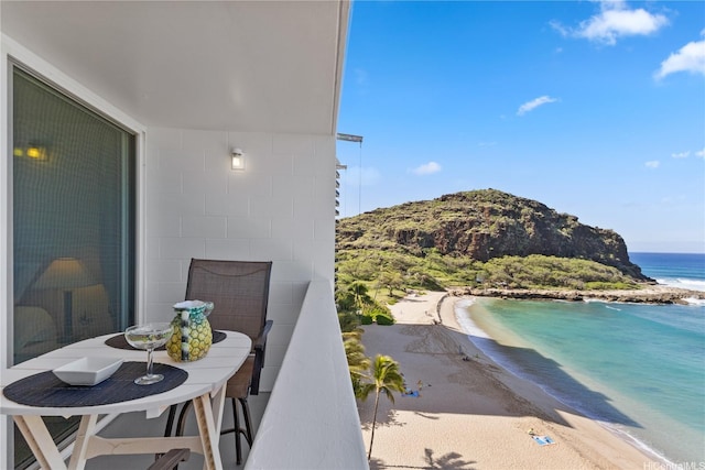 balcony featuring a water view and a beach view