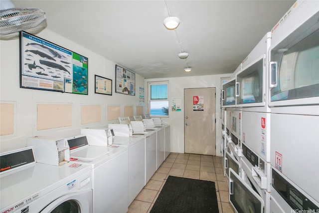 shared laundry area featuring independent washer and dryer, stacked washer / drying machine, and light tile patterned flooring
