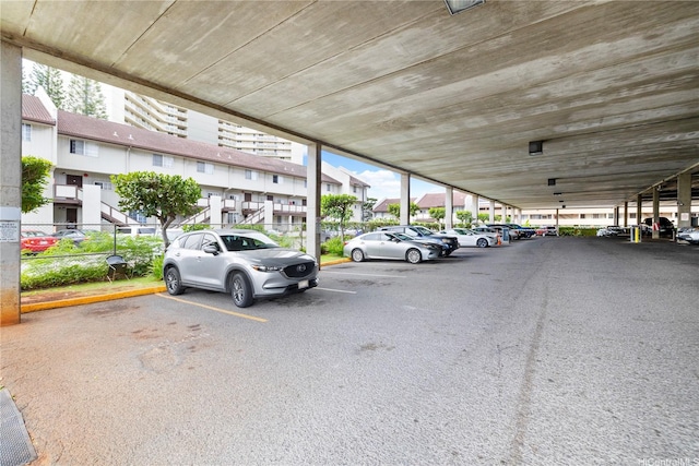 uncovered parking lot with a residential view