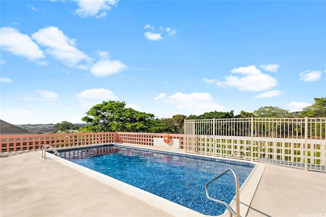 view of swimming pool with fence, a fenced in pool, and a patio