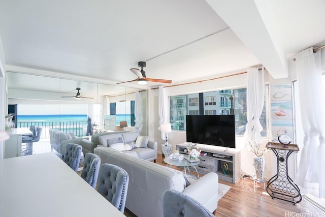living area with ceiling fan and wood finished floors