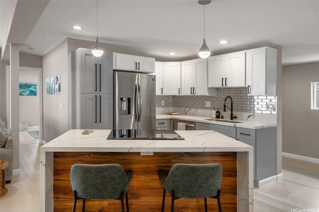 45-008 Mahalani Cir, Kaneohe, HI 96744 - kitchen featuring baseboards, tasteful backsplash, light stone counters, a sink, and appliances with stainless steel finishes