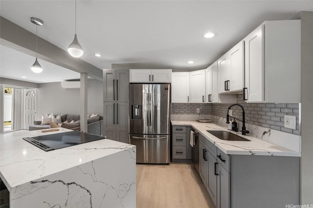 45-008 Mahalani Cir, Kaneohe, HI 96744 - kitchen with gray cabinets, tasteful backsplash, a sink, light stone counters, and black appliances