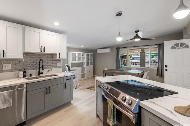 45-008 Mahalani Cir, Kaneohe, HI 96744 - kitchen featuring decorative backsplash, light stone countertops, an AC wall unit, a sink, and appliances with stainless steel finishes