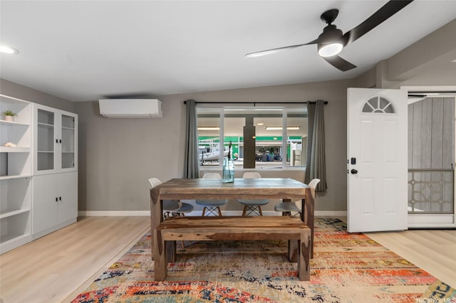 45-008 Mahalani Cir, Kaneohe, HI 96744 - dining space with an AC wall unit, light wood-style floors, ceiling fan, and baseboards