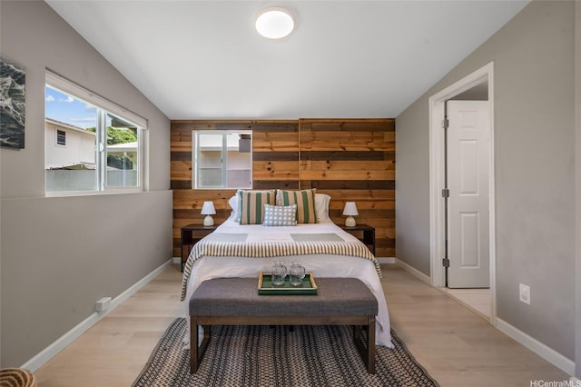 45-008 Mahalani Cir, Kaneohe, HI 96744 - bedroom featuring baseboards, wood walls, vaulted ceiling, and light wood-style floors