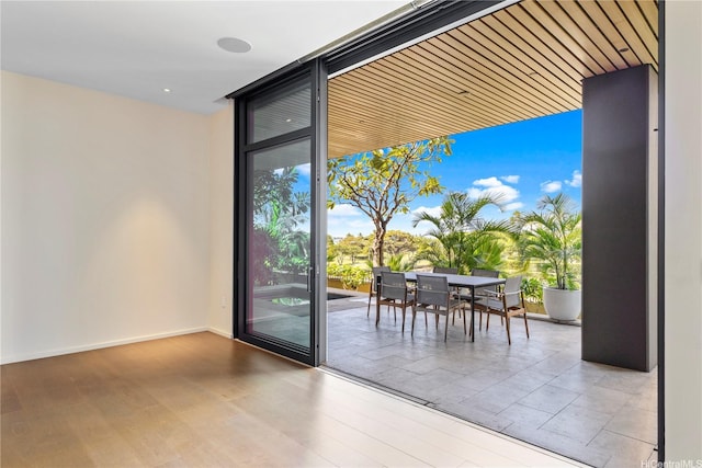 entryway featuring baseboards and expansive windows