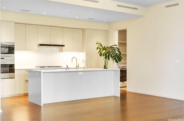 kitchen featuring visible vents, light countertops, and light wood-style flooring