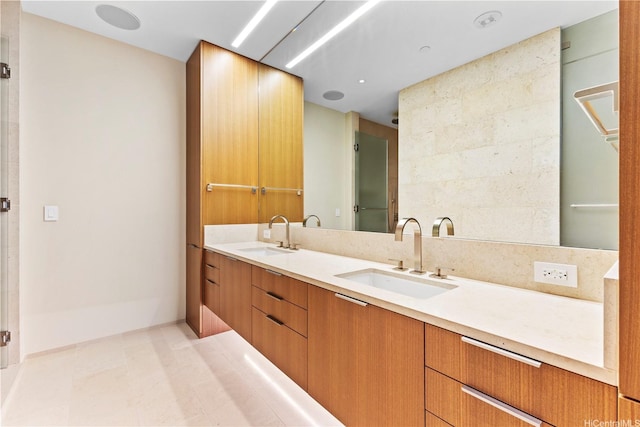full bathroom with double vanity, a sink, and tile patterned floors